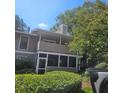 Tan condo building with screened porch and balcony at 613 Wynnes Ridge Cir, Marietta, GA 30067