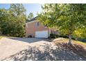 Attached two-car garage with a large driveway at 2600 Wells Sw Ter, Atlanta, GA 30331