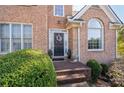Brick front entrance with a black door and lush greenery at 2600 Wells Sw Ter, Atlanta, GA 30331