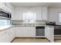 Bright kitchen with white cabinets, stainless steel appliances, and granite countertops at 3689 Laurie Woods Ln, Decatur, GA 30034