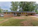Brick ranch house with yellow shutters and a spacious yard at 3689 Laurie Woods Ln, Decatur, GA 30034