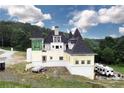 Luxury chateau under construction with unique architectural details and expansive grounds at 1197 Dee Kennedy Rd, Auburn, GA 30011