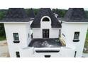Chateau-style home with a large rooftop deck and stunning architectural features at 1197 Dee Kennedy Rd, Auburn, GA 30011