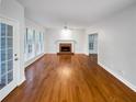 Bright living room with hardwood floors, fireplace, and plenty of natural light at 1512 Maplewood Ct, Woodstock, GA 30189
