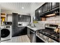 Modern kitchen with dark cabinetry, stainless steel appliances, and white subway tile backsplash at 5696 Kingsport Dr # 3, Atlanta, GA 30342