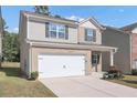 Two-story house with gray siding and a white garage door at 10922 Wheeler Trce, Hampton, GA 30228