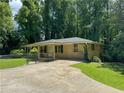 Brick ranch house with a large driveway and fenced yard at 57 Hillcrest Dr, Austell, GA 30168