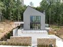 Modern farmhouse exterior with metal roof and stone accents at 1171 Lupo Loop, Chattahoochee Hills, GA 30268