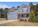 Two-story craftsman style home with gray siding, brick accents, and a landscaped lawn at 26 Broadstone Blvd, Acworth, GA 30101