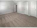 Spacious bedroom with neutral carpeting and ample closet space at 1861 Old Dogwood, Jonesboro, GA 30238