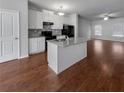 Modern kitchen with island, hardwood floors, and stainless steel appliances at 1861 Old Dogwood, Jonesboro, GA 30238