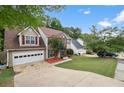 Two-story house with a large yard and driveway, situated in a residential neighborhood at 721 Simon Park Cir, Lawrenceville, GA 30045