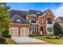 Brick two-story home with two-car garage and landscaped yard at 480 Lancashire Dr, Marietta, GA 30068