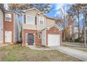 Attractive brick front exterior of a townhouse with garage at 5100 Windsor Forrest Ln, Atlanta, GA 30349