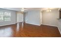 Open living room featuring hardwood floors and lots of natural light at 705 Chase Ln, Mcdonough, GA 30253