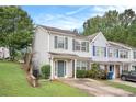 Two-story townhome with green door and driveway at 705 Chase Ln, Mcdonough, GA 30253
