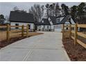 Long driveway leading to a two-story farmhouse with attached garage at 2259 County Line Rd, Acworth, GA 30101