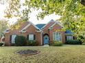 Brick house with a blue door and landscaped yard at 500 Chestnut Walk, Canton, GA 30114