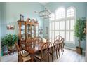 Formal dining room with large table, hardwood floors, and plant at 500 Chestnut Walk, Canton, GA 30114