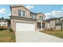 Two-story brick house with a white garage door and landscaped lawn at 7751 Plymouth Dr, Fairburn, GA 30213