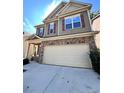 Two-story house with stone accents and a two-car garage at 3059 Woodward Down Trl, Buford, GA 30519