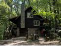 Log cabin with stone accents, deck, and private wooded lot at 7790 Atlanta Newnan Rd, Chattahoochee Hills, GA 30268
