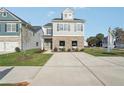 Two-story home with gray siding, brick accents, and a landscaped lawn at 2010 Wyndham Pl, Conyers, GA 30013