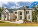 Two story house with front yard landscaping and walkway at 2004 Fontainbleau Dr, Conyers, GA 30094