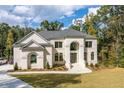 Two story house with front yard landscaping and walkway at 2004 Fontainbleau Dr, Conyers, GA 30094
