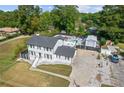 Two-story white house with black accents, pool, and detached garage at 3636 Evans Rd, Atlanta, GA 30340