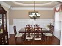 Formal dining room with chandelier and wainscoting at 3853 Locksley Trl, Douglasville, GA 30135
