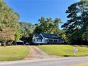 White house with a screened porch and a large yard at 3970 Norman Rd, Stone Mountain, GA 30083