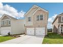 Two-story brick home with a two-car garage and well-manicured lawn at 3024 Viewpark Cir, Conyers, GA 30013