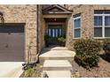 Brick front entrance with a dark brown door and sidelights at 105 Fairmont Trce, Fayetteville, GA 30214