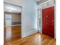 Bright entryway with hardwood floors, red door, and painted accent wall at 150 E Main St, Rutledge, GA 30663