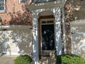 Front entrance of townhouse with brick exterior, columns, and double doors at 6148 Indian Wood Se Cir, Mableton, GA 30126