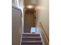 Upper level staircase with carpeted steps, neutral walls, and small table at 6148 Indian Wood Se Cir, Mableton, GA 30126