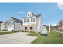 Two-story home with gray siding, brick accents, and a landscaped front yard at 1012 Northfield Dr, Conyers, GA 30013