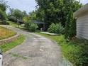 The home's exterior features a long driveway and a covered patio area at 2010 Driftwood Cir, Cumming, GA 30041