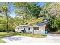 Ranch home with gray siding and driveway at 3215 Highway 20 Se, Conyers, GA 30013