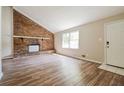 Spacious living room with brick fireplace and wood-look floors at 3215 Highway 20 Se, Conyers, GA 30013