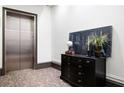 Building hallway with elevator and decorative console table at 360 Chambers St # 151, Woodstock, GA 30188