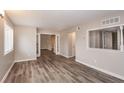 Open living room with hardwood floors and access to other rooms at 3814 N Camp Creek Sw Pkwy, Atlanta, GA 30331