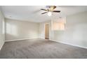 Bright living room with neutral walls and carpeting, open to kitchen at 4649 Big Valley Ct, Stone Mountain, GA 30083