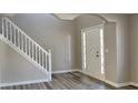 Bright entryway with hardwood floors and staircase at 12497 Lakeside Pkwy, Fayetteville, GA 30215