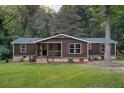 Single-story home with dark brown siding, stone accents, and a covered porch at 116 Southside Dr, Villa Rica, GA 30180