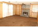 Spacious living room with a stone fireplace and built-in shelving at 3219 Boulder Brook Dr, Lithonia, GA 30038