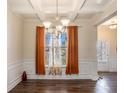 Bright dining room with hardwood floors and orange curtains at 188 Sophie Cir, Locust Grove, GA 30248