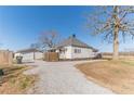 Ranch home with detached garage and gravel driveway at 2660 Gum Creek Church Rd, Loganville, GA 30052