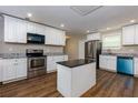 Modern kitchen with white cabinets, granite counters, and island at 2911 Glenwood Se Ave, Atlanta, GA 30317